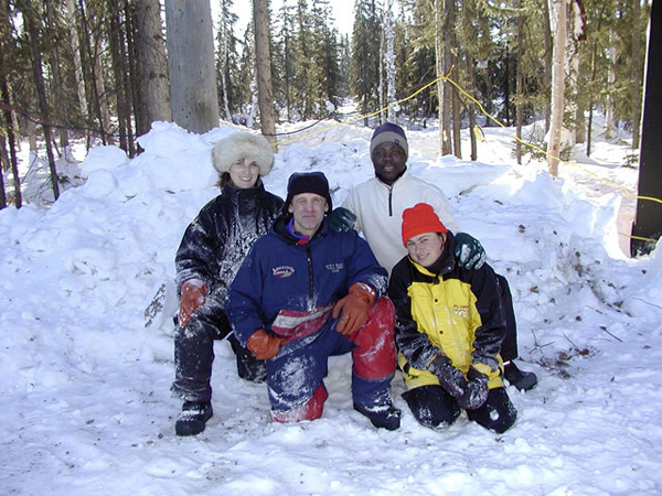 “Animal Parade” ice sculpture artists pose in snow at edge of woods. By Steve Brice, Heather Brown, Tjana Raukar, and Mario Amegee. Ice Alaska 2005