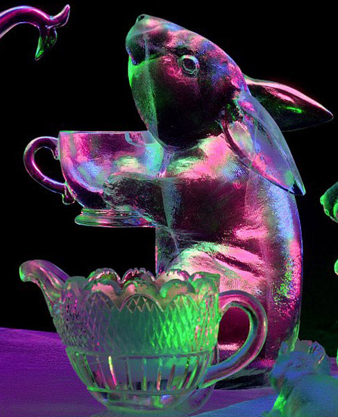 "Time for Tea" ice sculpture of centaur, detail little bunny being severed tea. Lit with colored lights against black background at night, violet and green colors. Photo by Patrick J. Endres. By Heather Brown, Aaron Costic, Steve Brice and Joan Brice World Ice Art Championships, 2006.