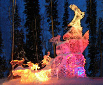 Baltos Charge ice sculpture at World Ice Art Competition in Fairbanks Alaska, photographed at night with colored lights.
