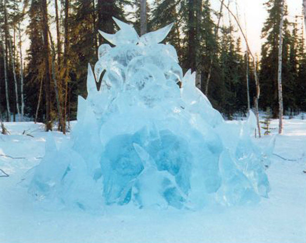 48 large buffalo skulls carved out of ice are stacked in a pile in this ice sculpture, called “Wascana,” reveals an unplanned image of a buffalo head within the sculpture. Patrica Leguen artist, for Ice Alaska event, photo by Berry Nishkian.