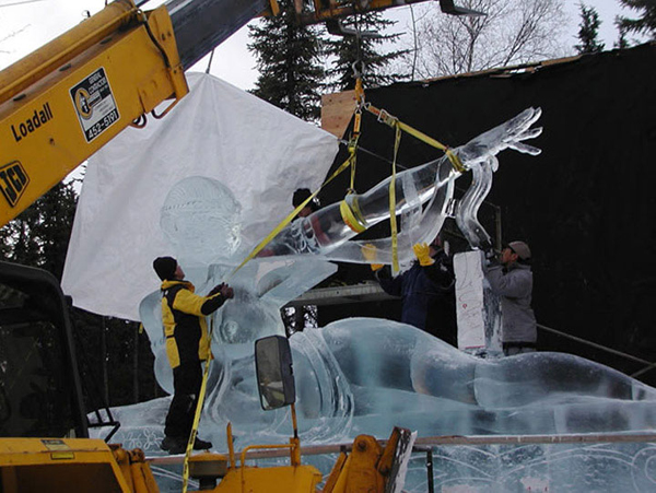 “Birth of Blue Bird,” by Junichi Nakamura his team (Junichi Nakamura, Daniel Reboltz, Shinichi Sawamura and Hitoshi Shimmoto) for Ice Alaska’s World Ice Art Championships, 2005. Four men and a hoist lift the ice sculpture’s arm into position.