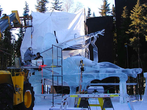 “Birth of Blue Bird,” by Junichi Nakamura his team (Junichi Nakamura, Daniel Reboltz, Shinichi Sawamura and Hitoshi Shimmoto) for Ice Alaska’s World Ice Art Championships. Four men and a hoist lift the ice sculpture’s arm into position.