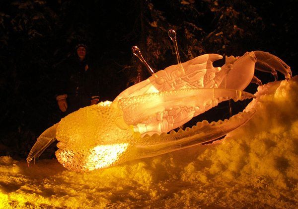 “Beach Walker,” by Junichi Nakamura and Steve Brice for Ice Alaska’s World Ice Art Championships. Crab ice sculpture finished, night under amber colored lights. Photo by Heather Brown.