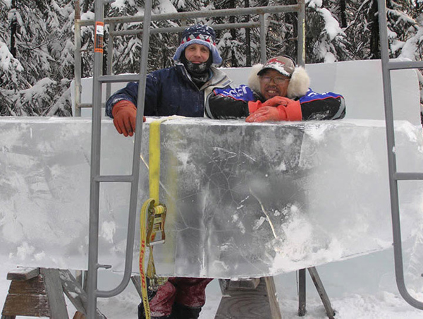 Ice blocks for what will become “Beach Walker,” by Junichi Nakamura and Steve Brice. Here, the artists pose with the ice. Ice Alaska’s World Ice Art Championships. 