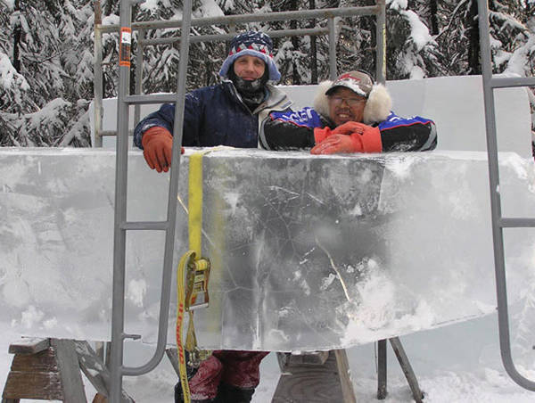 Ice blocks for what will become “Beach Walker,” by Junichi Nakamura and Steve Brice. Here, the artists pose with the ice. Ice Alaska’s World Ice Art Championships.