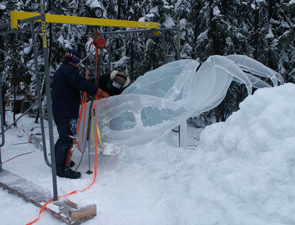 “Beach Walker,” by Junichi Nakamura and Steve Brice for Ice Alaska’s World Ice Art Championships. Crab ice sculpture in progress, artists working.