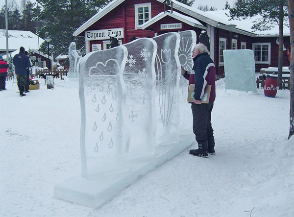 “Kai Tormikoski and Mauno Akhkisalo's sculpture "Four Seasons" 4 ice panels with simple elements of weather carved into them, representing the seasons. Kalajoki, Finland 2004. Visitor touching the surface of the ice sculpture.