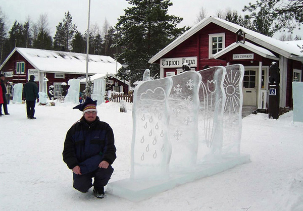 “Kai Tormikoski and Mauno Akhkisalo's sculpture "Four Seasons" 4 ice panels with simple elements of weather carved into them, representing the seasons. Kalajoki, Finland 2004. Here Kai kneels next to the sculpture. Photo by Mauno Aihkisalo.