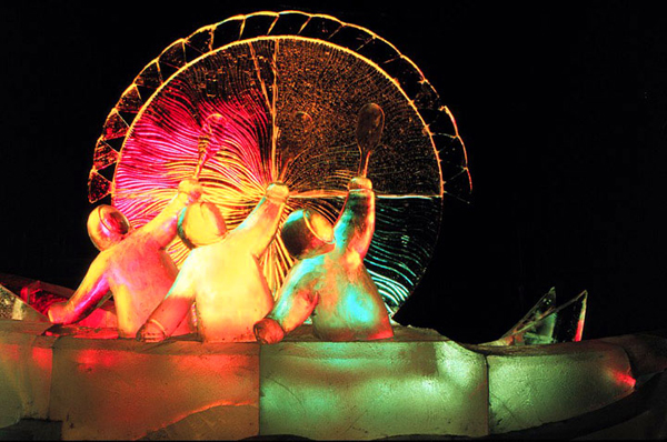 3 Inuit in a boat with abstract sun behind them. Colorful, wonderful textures. Vladimir Zhikhartsev, Nadya Fedotova and Andrei Trifonov of Russia for Ice Alaska event 1998. Photo by Patrick J. Endres at AlaskaPhotoGraphics