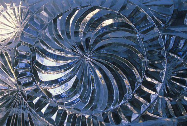 Vladimir Zhikhartsev, detail on an abstract ice sculpture. Pattern carved in the ice, spiral. Photo credit: Patrick J. Endres at AlaskaPhotoGraphics.