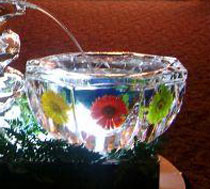 An ice fountain created by “Art Below Zero,” featuring embedded Gerber daisies.